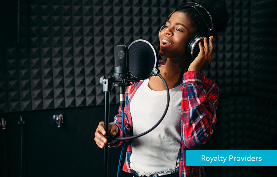 Black Woman singing in an audio studio demonstrating how Hyperwallet helps Royalty Providers